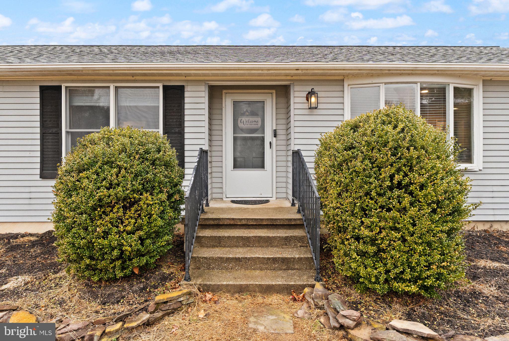 14068 Carriage Ford Road Nokesville, VA 20181 - Photo 8 of 48 a front view of a house with plants and garden