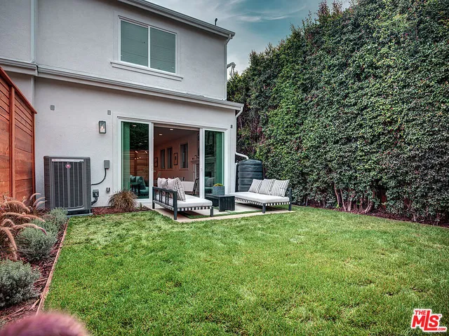 a view of a house with backyard porch and sitting area