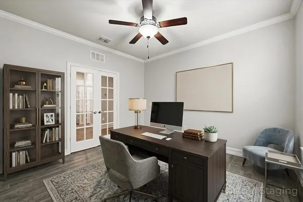 a view of a workspace with furniture and a window