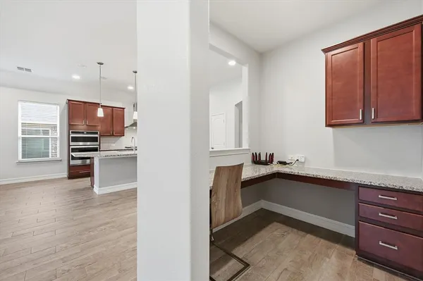 a kitchen with stainless steel appliances kitchen island granite countertop a refrigerator and a stove top oven