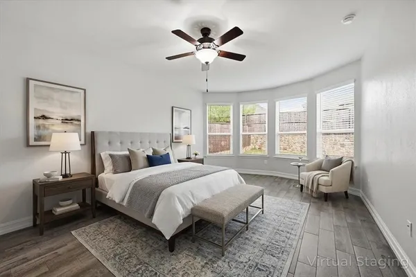 a spacious bedroom with a bed and wooden floor