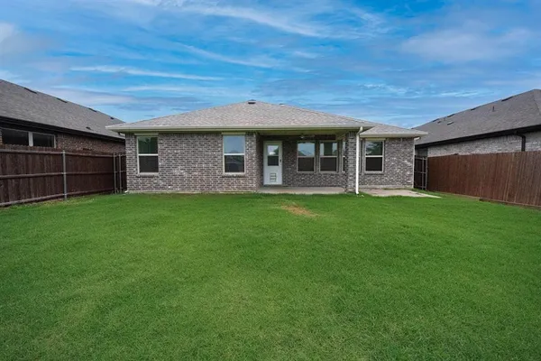 a view of a house with a yard and sitting area