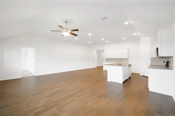 a view of a kitchen with a sink and a stove top oven