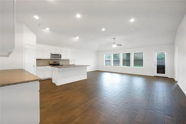a view of kitchen with cabinets and wooden floor