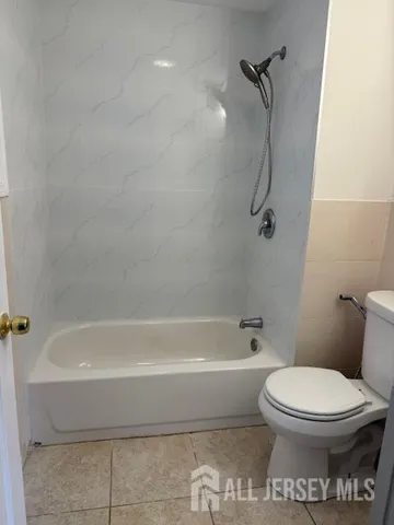 a bathroom with a toilet and a bath tub