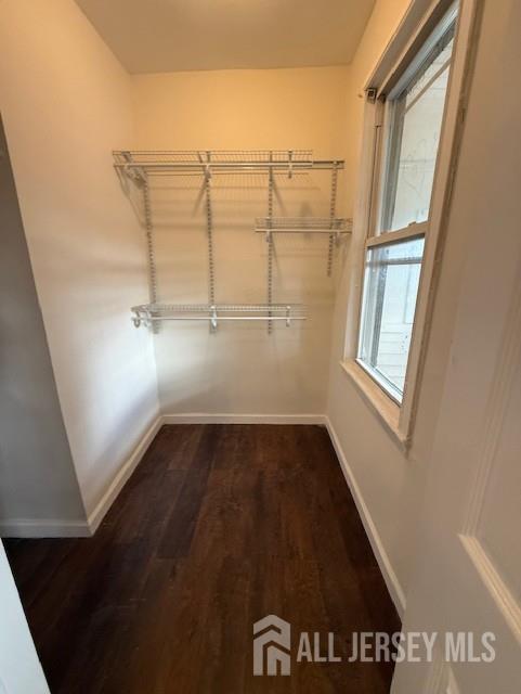 423 Augustine Place, Unit 2 Perth Amboy, NJ 08861 - Photo 6 of 8 an empty room with wooden floor and windows