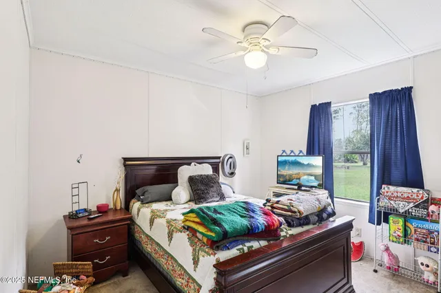 a bedroom with a bed and a chair in it