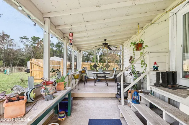 a living room with patio furniture and a large window