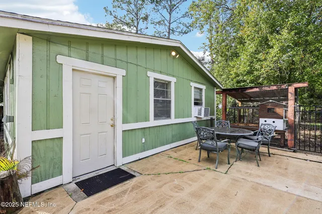 a living room with furniture a fireplace and white walls