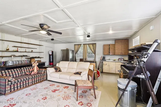 a living room with furniture gym equipment and a view of kitchen