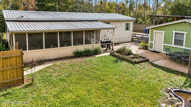 an aerial view of residential houses with outdoor space and trees