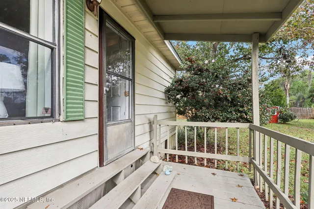 a view of a balcony with yard