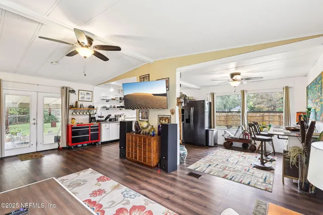 a living room with furniture and a wooden floor
