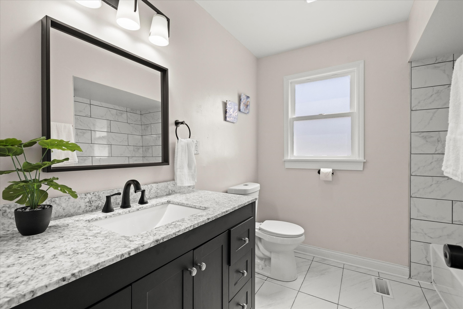 30 Broadway Chicago Heights, IL 60411 - Photo 9 of 25 a bathroom with a granite countertop sink a toilet and mirror