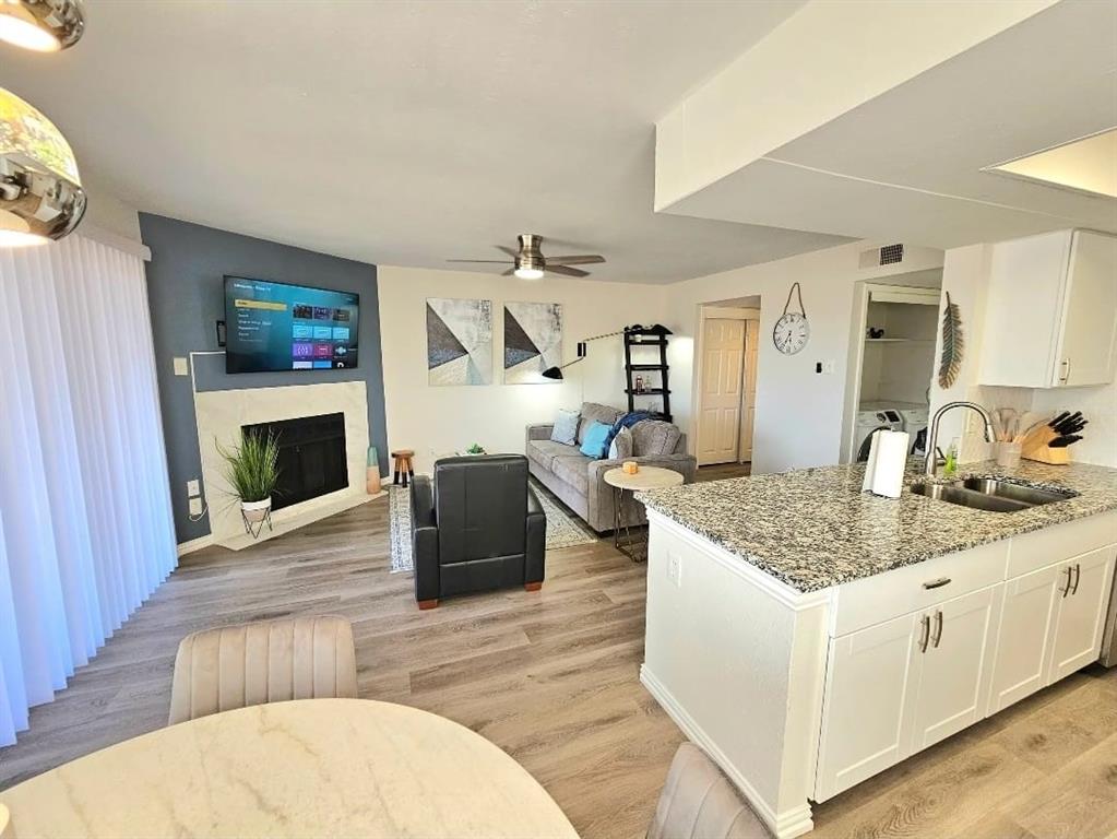 4460 Chaha Road, Unit 201 Garland, TX 75043 - Photo 1 of 16 a living room with granite countertop furniture a fireplace and a flat screen tv