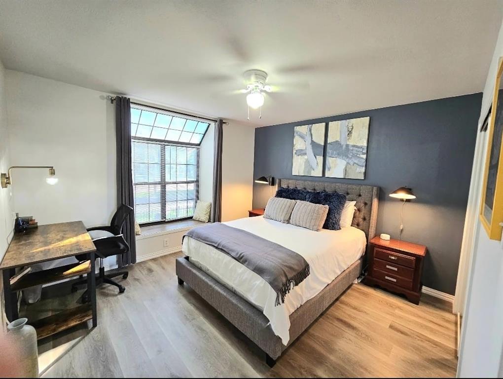 4460 Chaha Road, Unit 201 Garland, TX 75043 - Photo 11 of 16 a bedroom with a bed and wooden floor