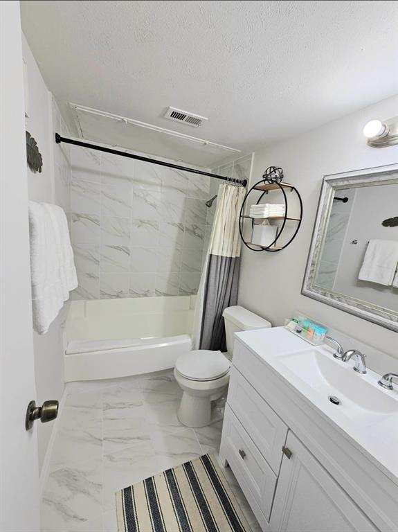 4460 Chaha Road, Unit 201 Garland, TX 75043 - Photo 12 of 16 a bathroom with a sink a toilet and a bathtub