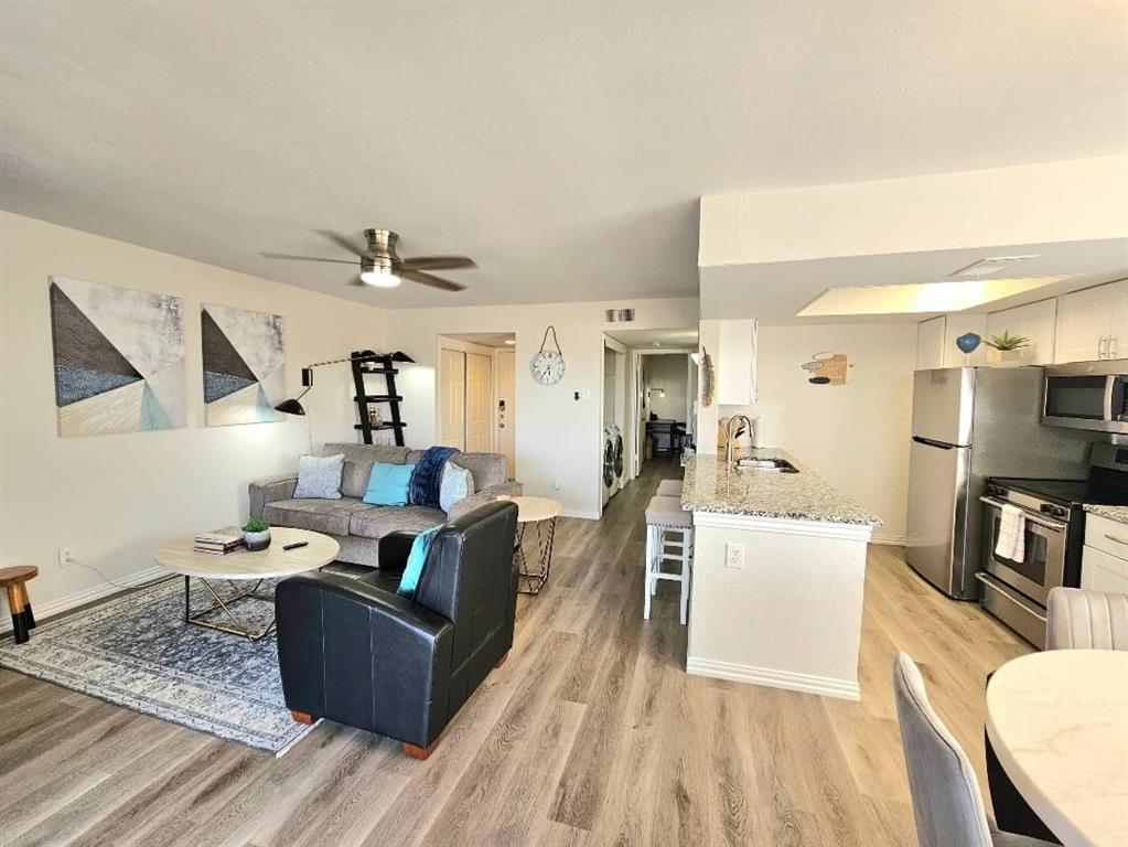 4460 Chaha Road, Unit 201 Garland, TX 75043 - Photo 5 of 16 a living room with furniture and a flat screen tv