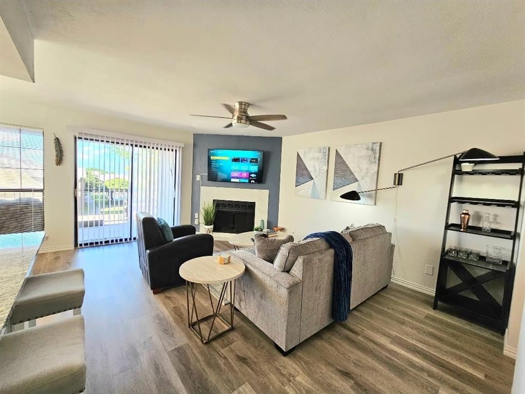 4460 Chaha Road, Unit 201 Garland, TX 75043 - Photo 9 of 16 a living room with furniture a flat screen tv and a fireplace