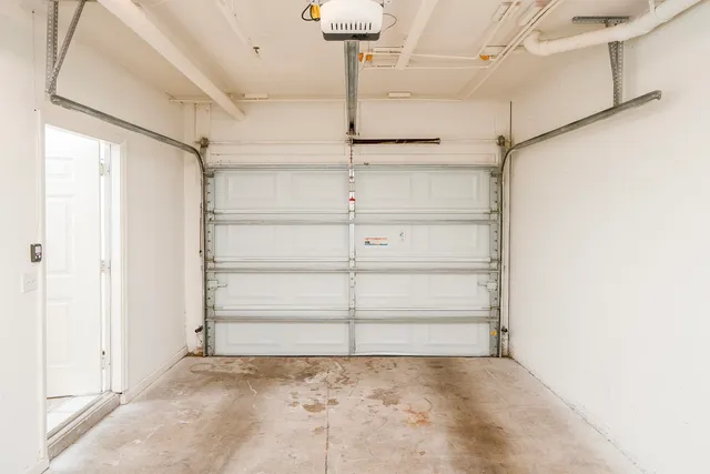 an aerial view of ocean and residential houses with outdoor space