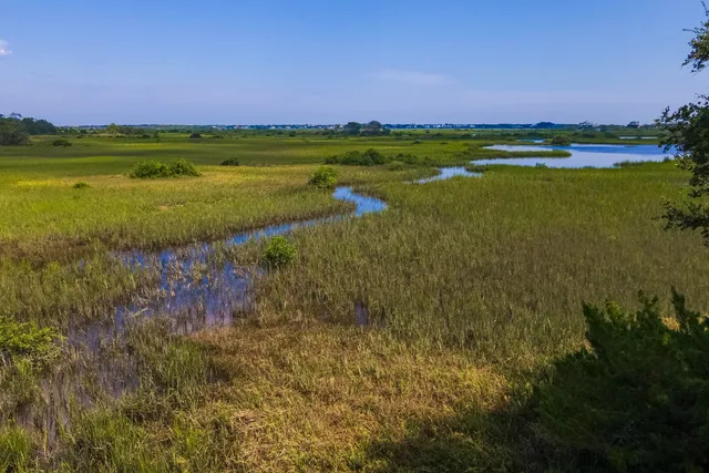 a view of a lake with a house in the background