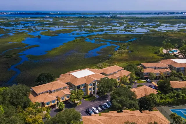 a view of a hallway with wooden floor and entryway