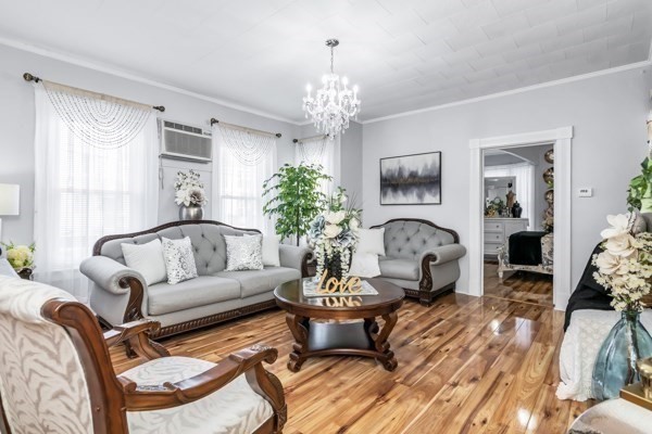 11 Cambridge Street Lawrence, MA 01843 - Photo 7 of 40 a living room with furniture a chandelier and a window