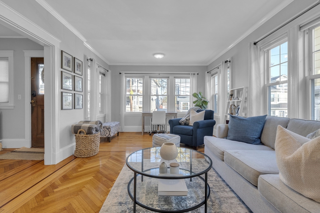 173 Train Street, Unit 1 Boston, MA 02122 - Photo 1 of 13 a living room with furniture and a large window