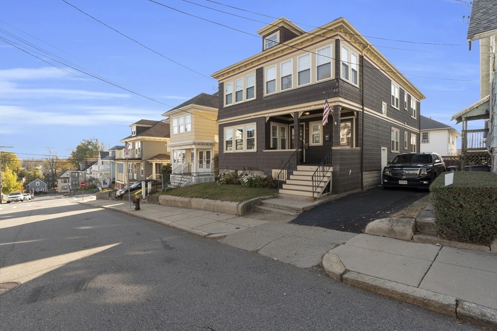 173 Train Street, Unit 1 Boston, MA 02122 - Photo 13 of 13 a front view of a building with cars parked