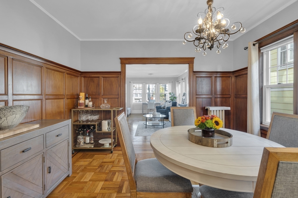 173 Train Street, Unit 1 Boston, MA 02122 - Photo 7 of 13 a dining room with chandelier and wooden floor