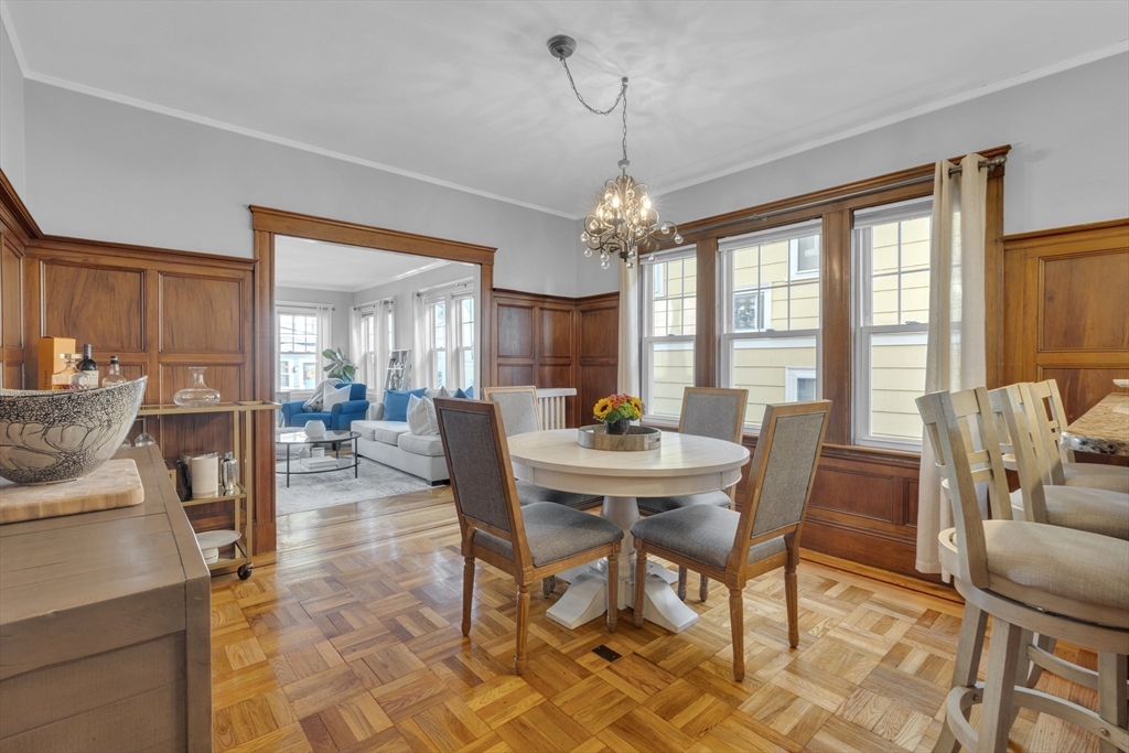 173 Train Street, Unit 1 Boston, MA 02122 - Photo 8 of 13 a view of a dining room with furniture window and wooden floor