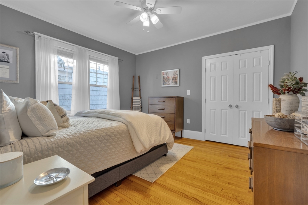 173 Train Street, Unit 1 Boston, MA 02122 - Photo 9 of 13 a bedroom with a bed and wooden floor