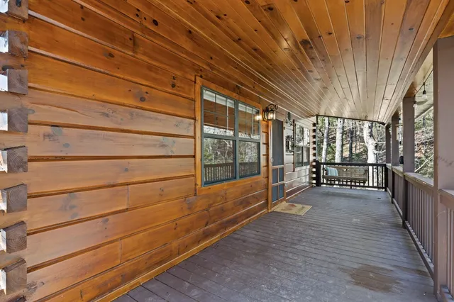 a view of a porch with wooden floor and iron stairs