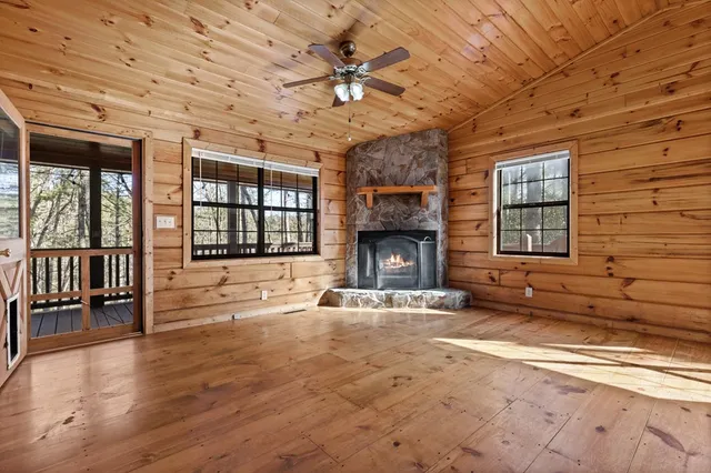 a view of an empty room with a fireplace and a window