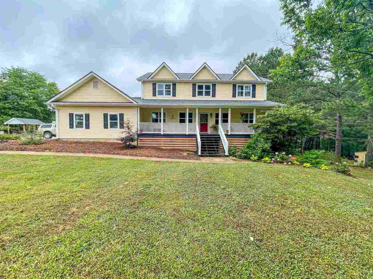 930 Carl Davis Road Northwest Monroe, GA 30656 - Photo 1 of 1 a front view of a house with a garden and trees