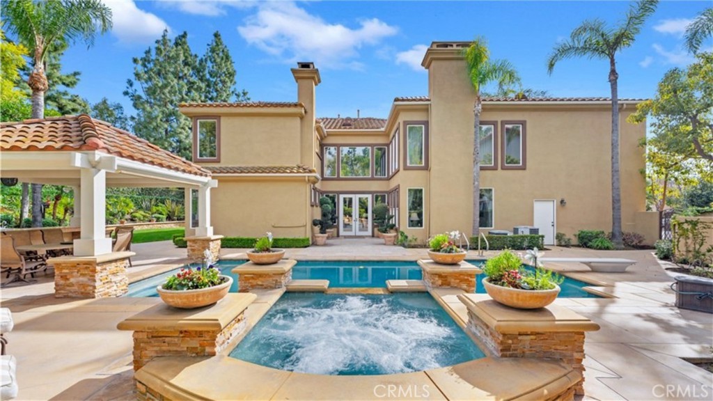 a view of a patio with couches table and chairs and potted plants