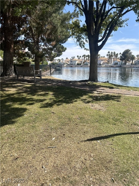 3150 North Soft Breezes Drive, Unit 1033 Las Vegas, NV 89128 - Photo 11 of 14 View of green lawn with a water view and a residen