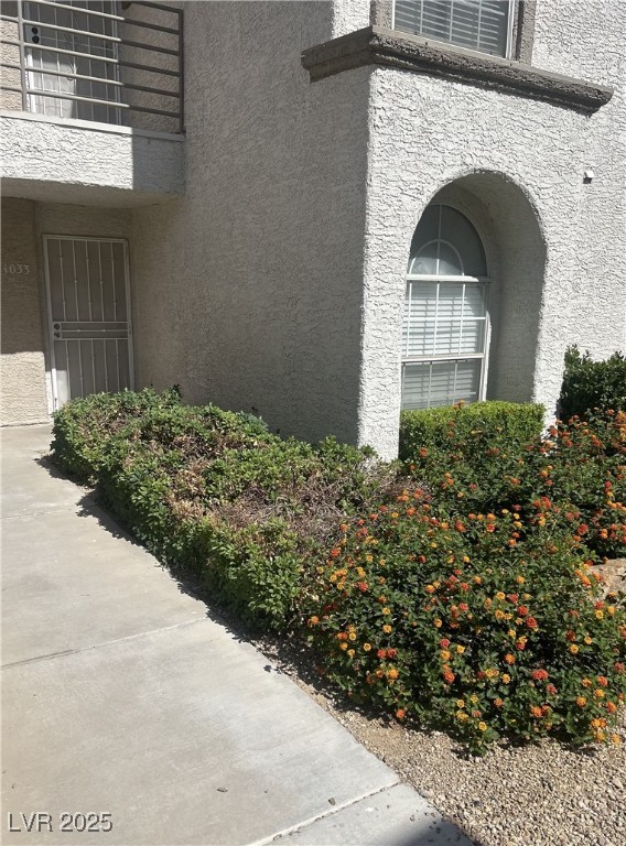 3150 North Soft Breezes Drive, Unit 1033 Las Vegas, NV 89128 - Photo 14 of 14 View of side of property featuring stucco siding
