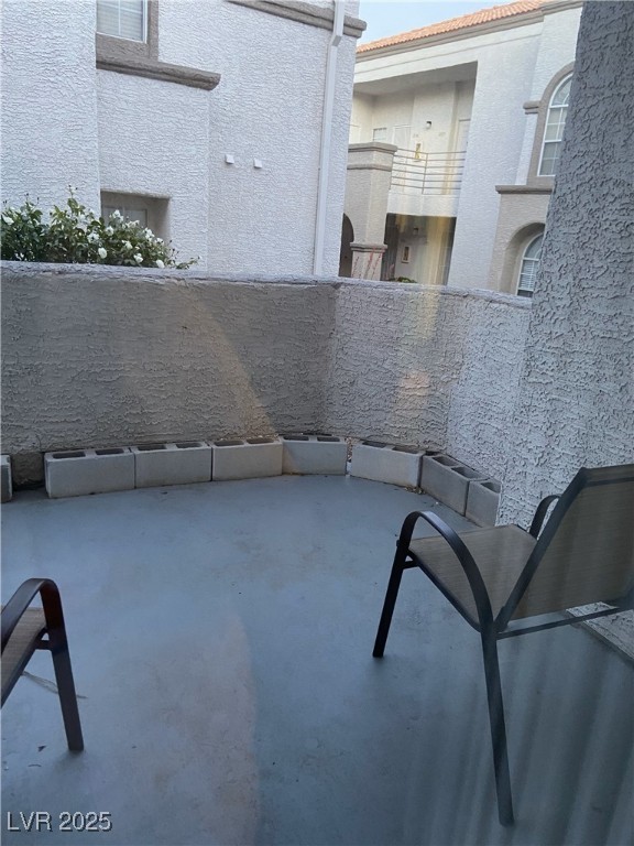 3150 North Soft Breezes Drive, Unit 1033 Las Vegas, NV 89128 - Photo 3 of 14 View of patio featuring a balcony