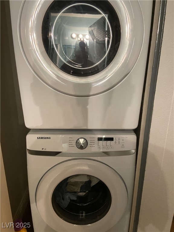 3150 North Soft Breezes Drive, Unit 1033 Las Vegas, NV 89128 - Photo 4 of 14 Laundry room featuring stacked washer and clothes