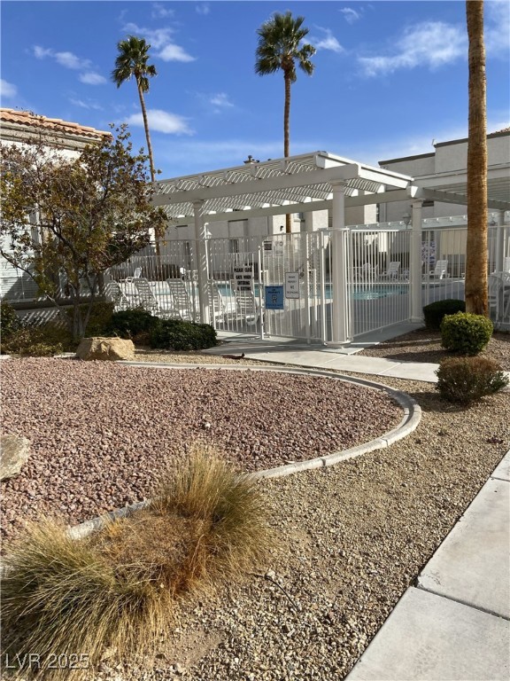3150 North Soft Breezes Drive, Unit 1033 Las Vegas, NV 89128 - Photo 8 of 14 View of home's community with a pergola and a swim