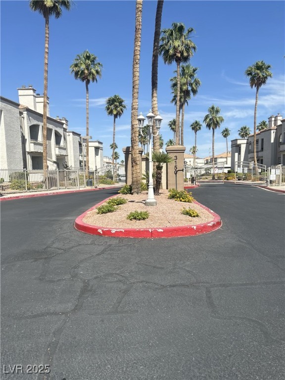 3150 North Soft Breezes Drive, Unit 1033 Las Vegas, NV 89128 - Photo 9 of 14 View of asphalt road with a gate, a residential vi