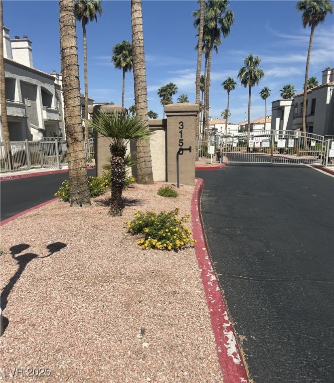 3150 North Soft Breezes Drive, Unit 1033 Las Vegas, NV 89128 - Photo 10 of 14 View of asphalt road with curbs, a gated entry, an