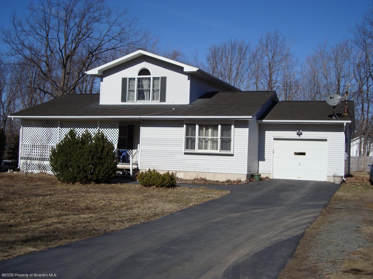 228 Winona Road Mount Pocono, PA 18344 - Photo 2 of 13 a front view of a house with a yard