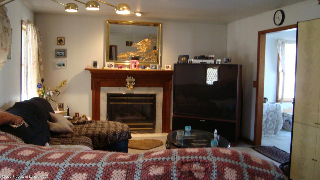 228 Winona Road Mount Pocono, PA 18344 - Photo 3 of 13 a living room with furniture and a fireplace