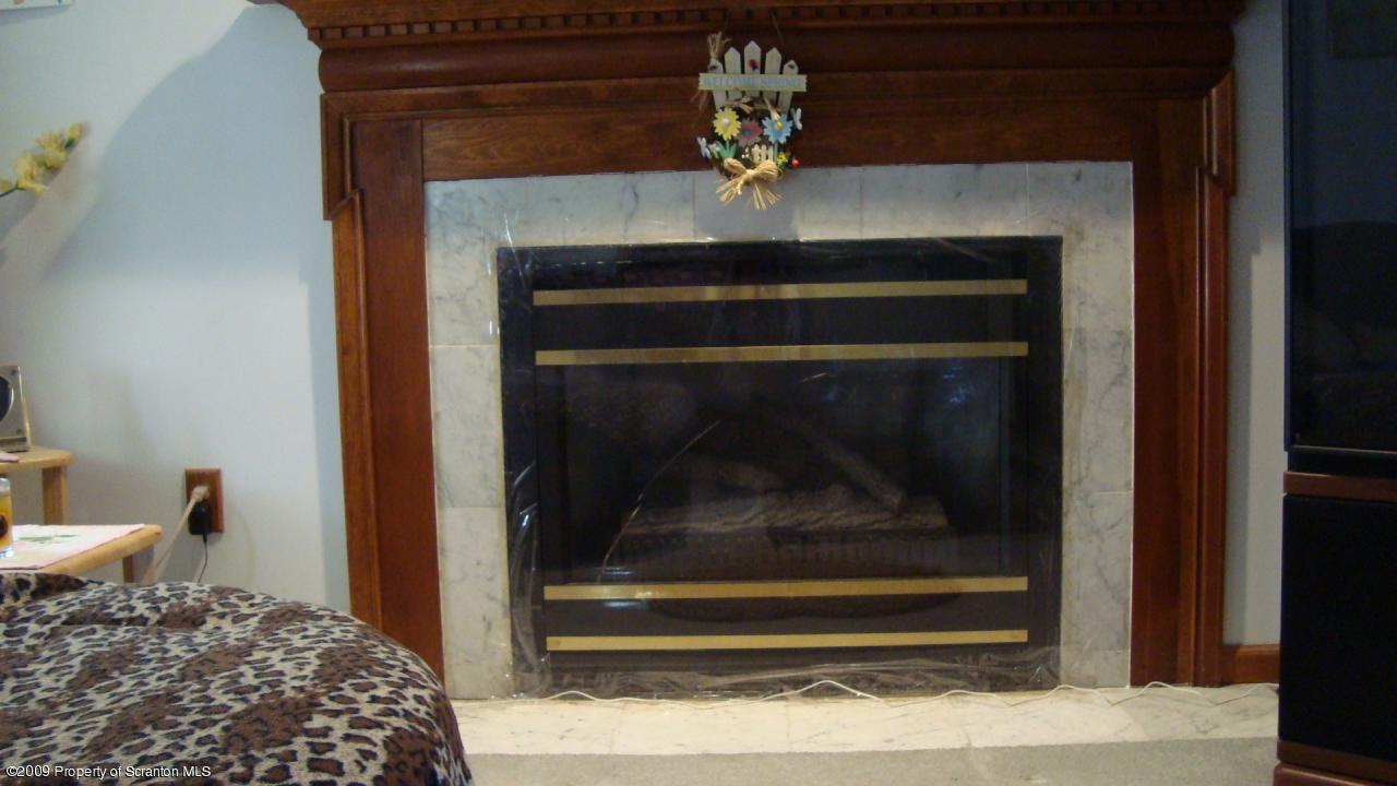 228 Winona Road Mount Pocono, PA 18344 - Photo 4 of 13 a room with a fireplace and wooden floor