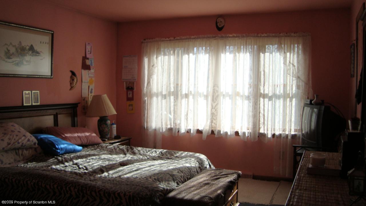 228 Winona Road Mount Pocono, PA 18344 - Photo 8 of 13 a bedroom with a bed and wooden floor