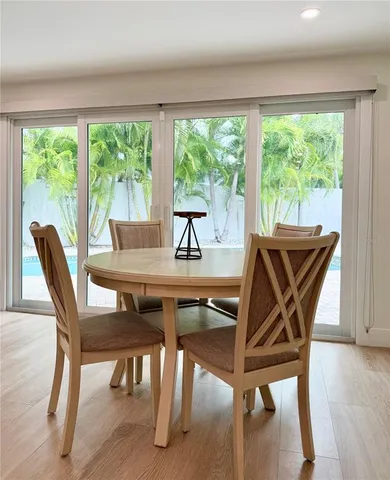 a view of a dining room with furniture and wooden floor