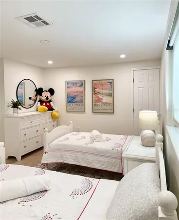 a bedroom with a bed and a large mirror