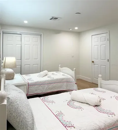 a bedroom with a bed and a couch